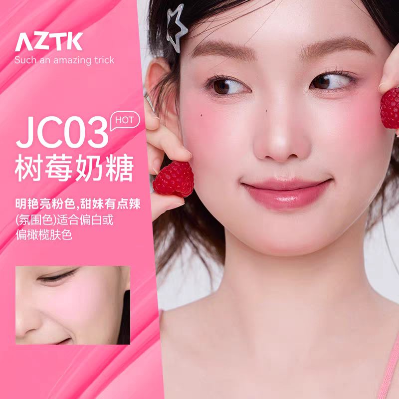 Woman with pink makeup holding raspberries, AZTK brand visible