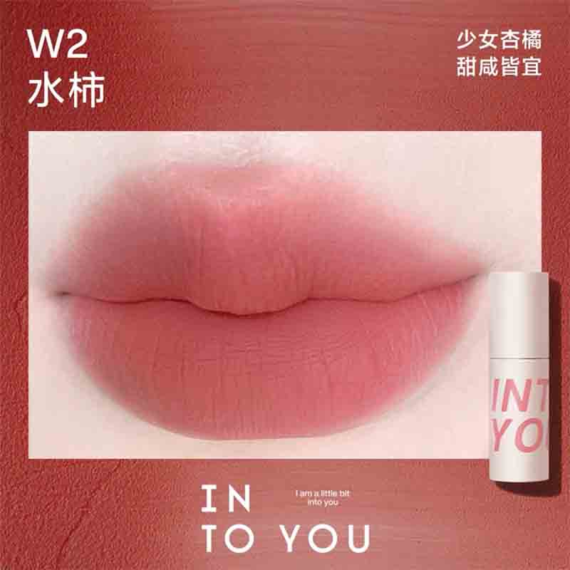 INTO YOU Airy Lip & Cheek Mud in W2, offering a warm, apricot shade for a sweet and youthful look