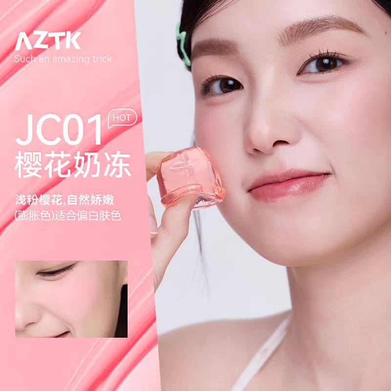 Woman holding a pink cosmetic product with AZTK branding on a white background