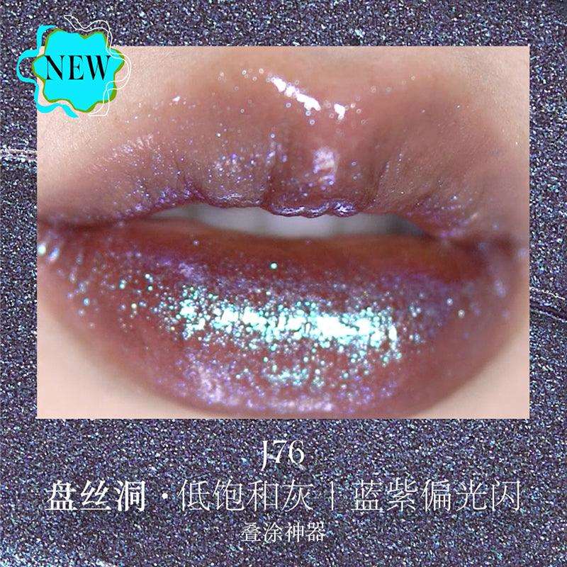 Close-up of lips wearing Girlcult The Classic of Bizarre Tales Lip Glaze in J76, showing a low-saturation grayish hue with blue-purple iridescent sparkle