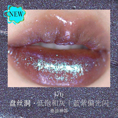 Close-up of lips wearing Girlcult The Classic of Bizarre Tales Lip Glaze in J76, showing a low-saturation grayish hue with blue-purple iridescent sparkle