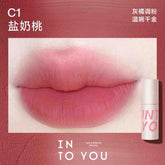 INTO YOU Airy Lip & Cheek Mud in C1, offering a delicate peachy-pink tone for a soft, feminine touch