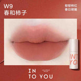 INTO YOU Airy Lip & Cheek Mud in W9, displaying a vibrant persimmon shade for a fresh and youthful appearance.