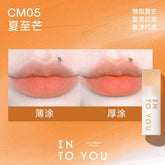 INTO YOU Cloudy Lip Mud in CM05, featuring a bright mango-orange shade, ideal for a bold and summery makeup look.