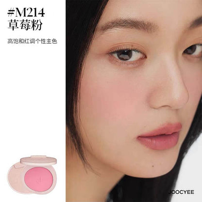 Model wearing JOOCYEE New Loose Powder Matte Blusher in shade M214, a vibrant strawberry pink that adds a pop of color to the cheeks with a matte finish