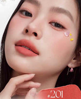 Model wearing Judydoll lip cream 201, featuring an apricot pink and astringent rose color combination for a radiant look

